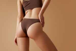 Woman in Scottsdale, wearing bikini, seen from behind after liposuction