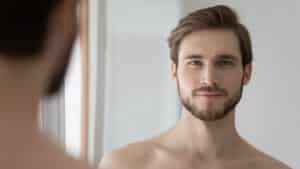 Man with defined jawline and refreshed facial appearance after male facelift.